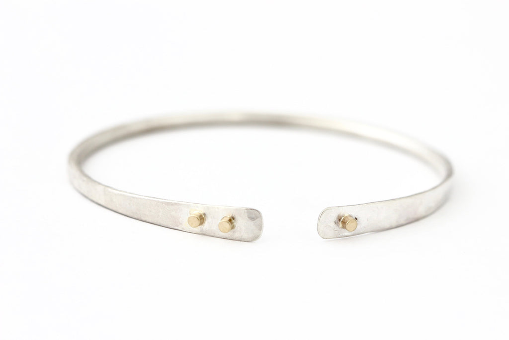 Hammered sterling silver bracelet with 14k yellow gold buttons 